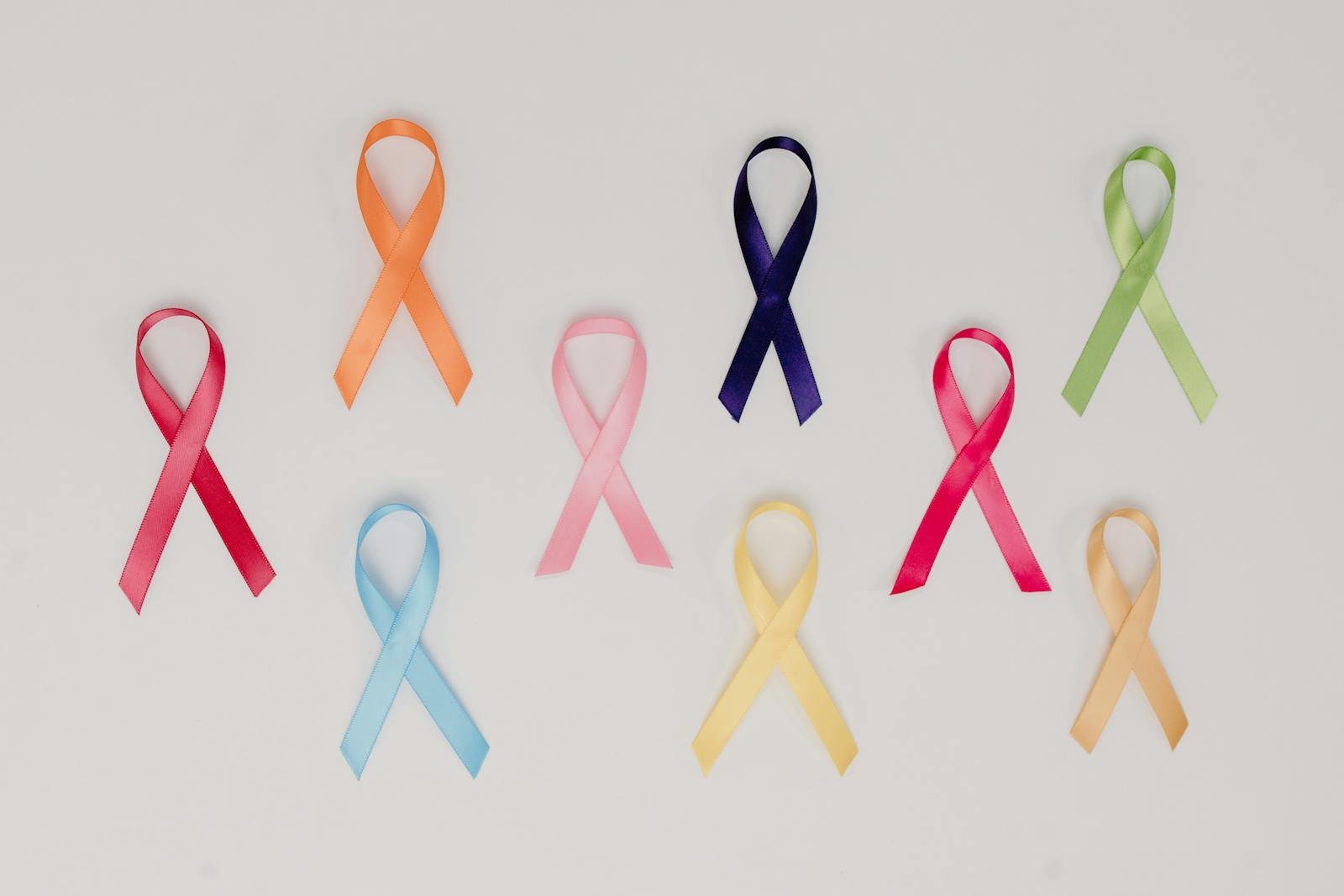A collection of colorful awareness ribbons symbolizing various causes on a white background.